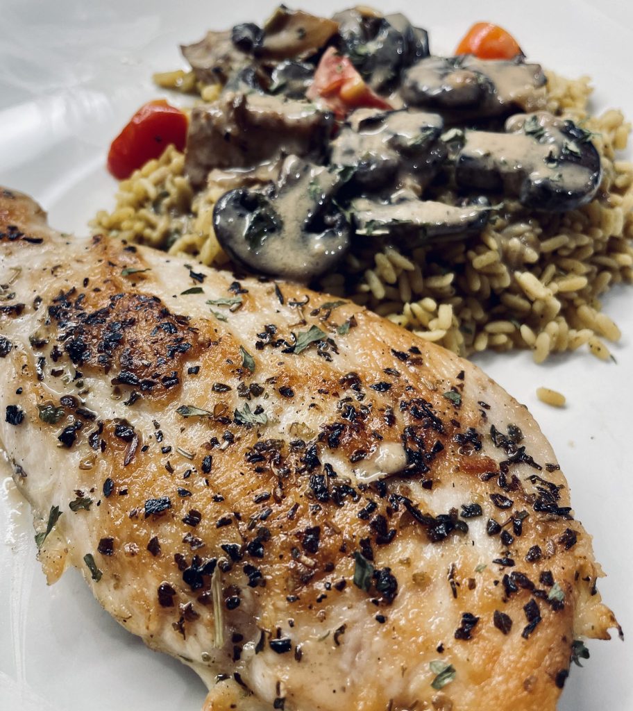 Creamy dijon chicken with rice and sauteed mushrooms, potatoes, and tomato