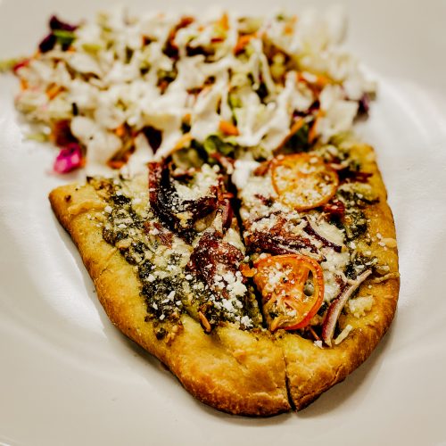 Smoked flatbread with brisket and pesto on plate