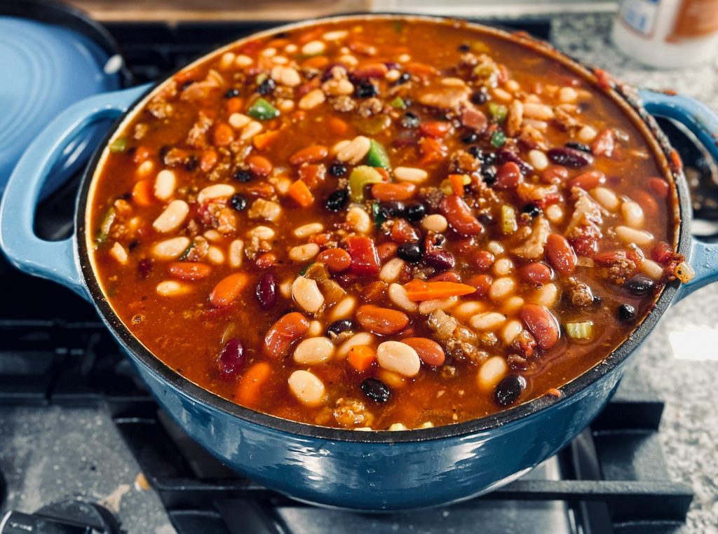 Zoomed out view of chili cooking in pot