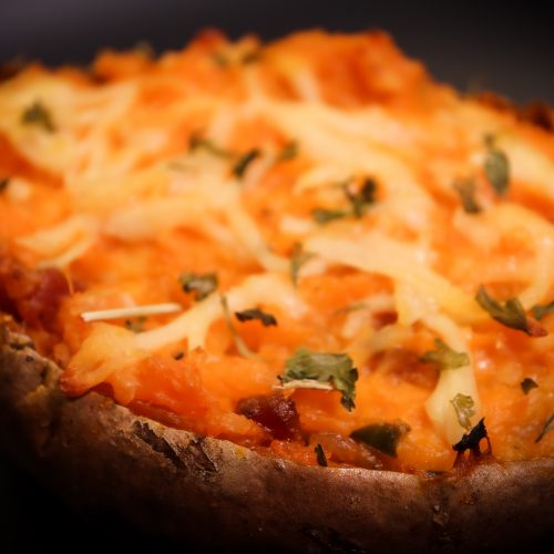 Close up of Twice Baked Sweet Potato in Black Bowl