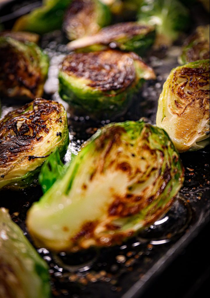 Sautéed Brussels Sprouts being cooked on griddle