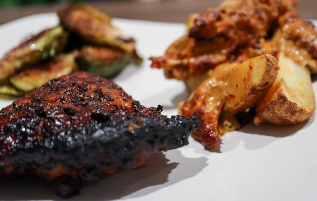 Plate of Chicken Thighs with Potato Wedges and Brussels Sprouts