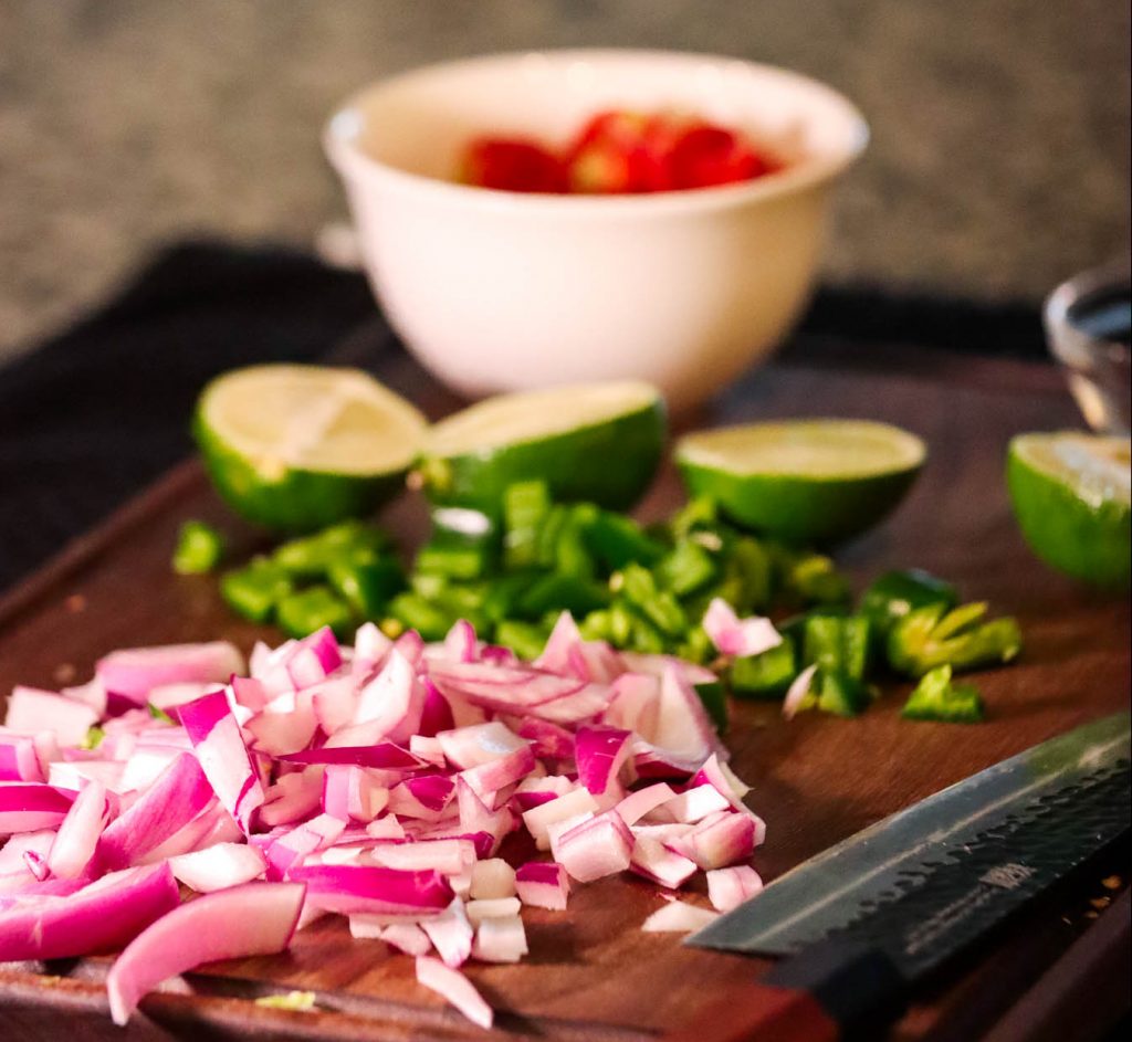 Chopped ingredients for Shrimp Ceviche on chopping board